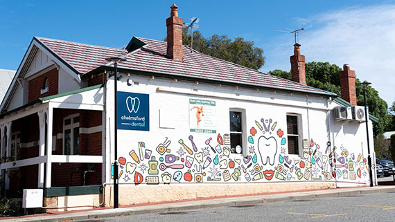 The side of a dental practice with cartoon branding.