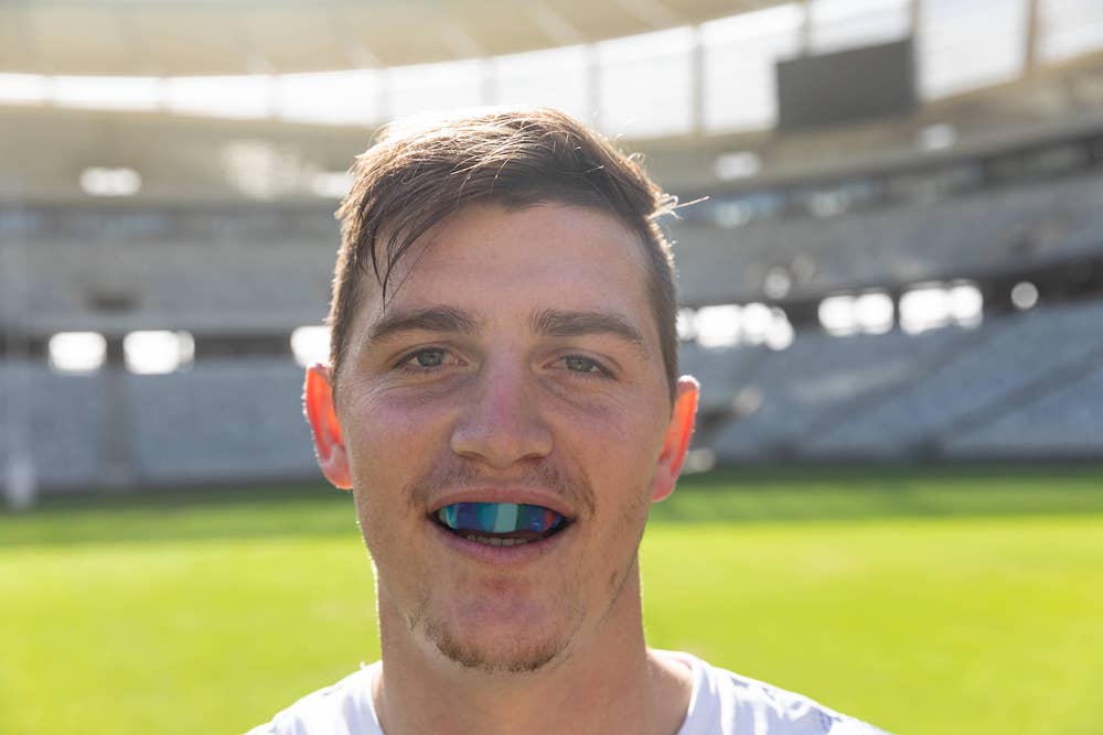 A football player with a custom mouth guard.