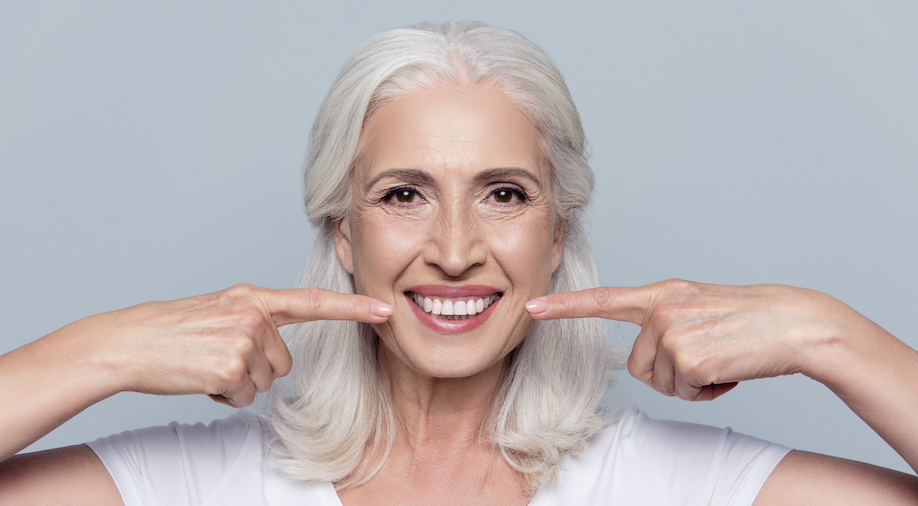 An older lady with white and beautiful teeth proving anyone can achieve a whiter smile. 