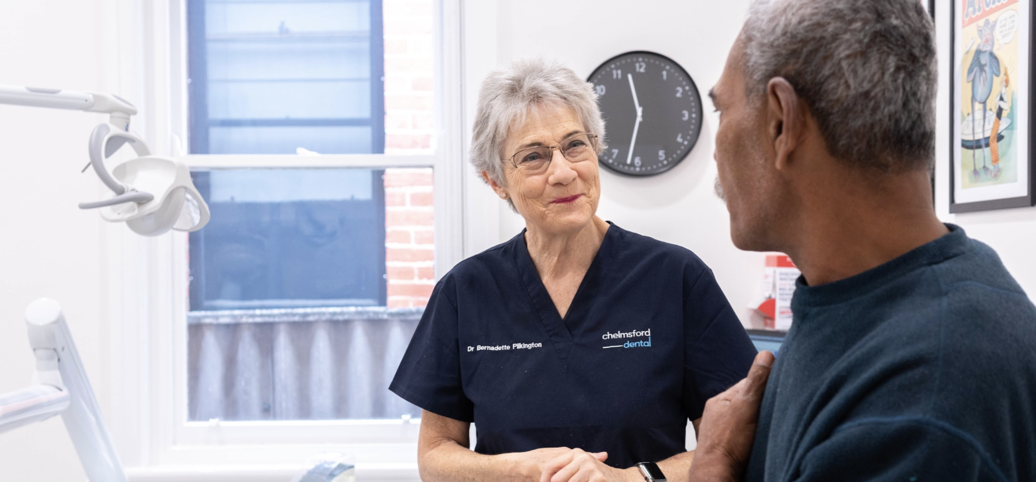 A dentist talking about options with a patient.