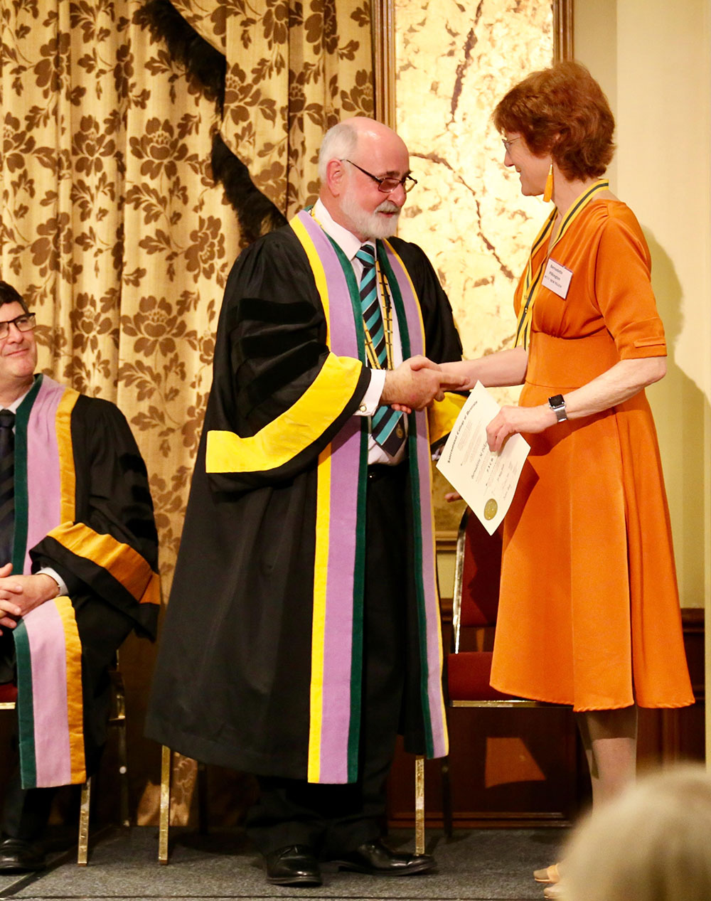 Bernadette on stage receiving a certificate.