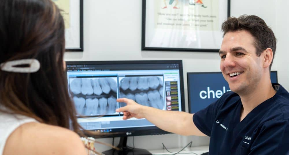 Dentist showing x-ray result to patient