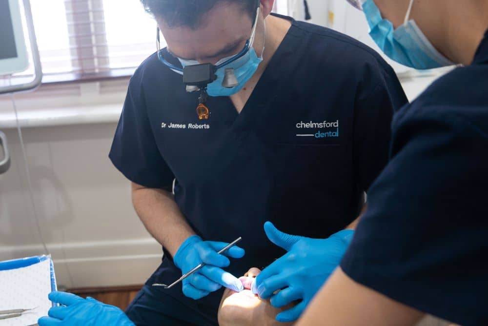 Dentist examining patient's teeth