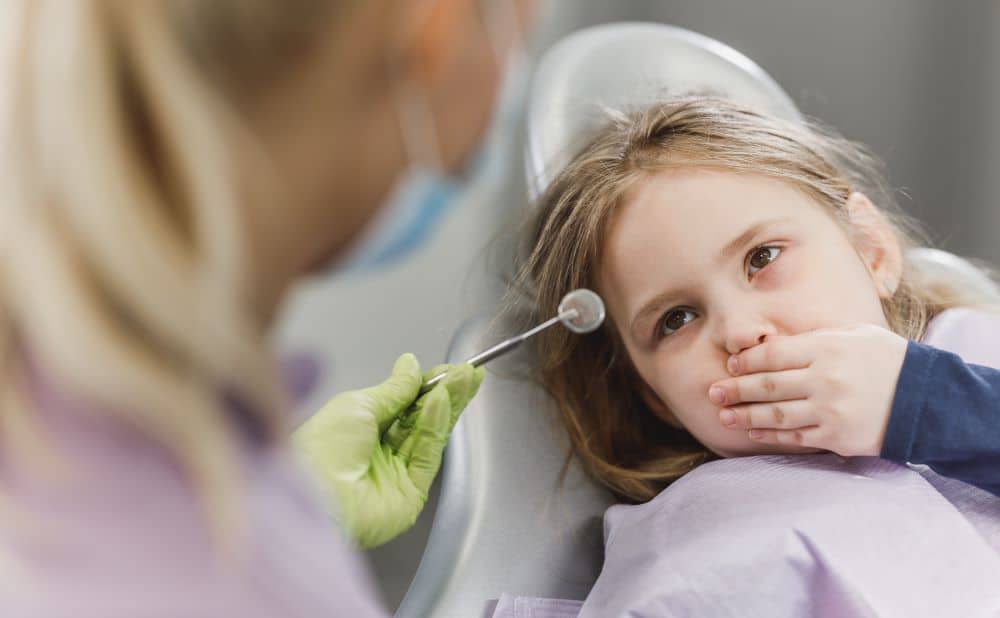 Child scared to open her mouth, dental appointment.