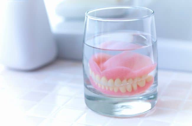 Dentures soaked in water.