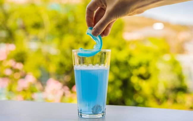 Deep cleaning mouthguard using denture cleaner.