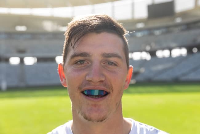 Male rugby player wearing mouthguard.