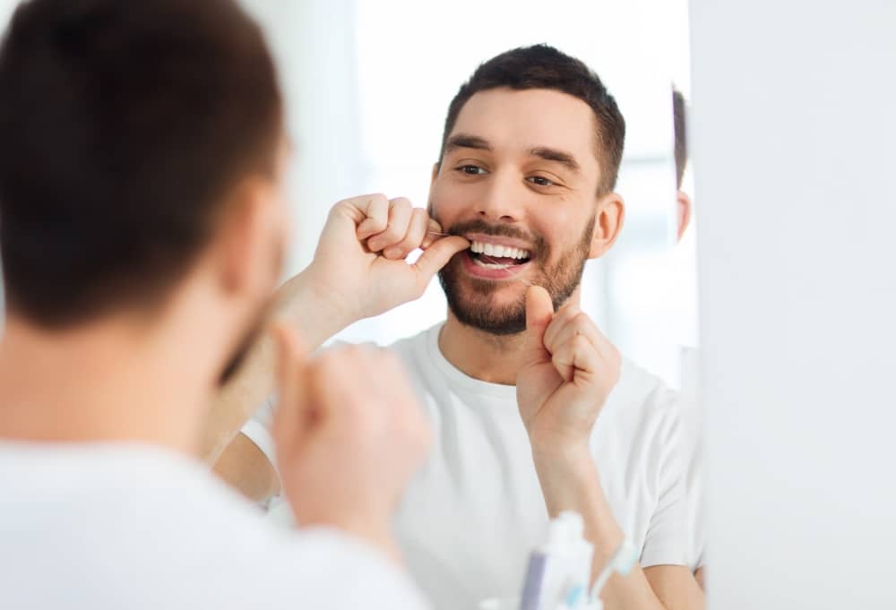 Flossing helps remove plaque and debris between teeth where your toothbrush may not reach.