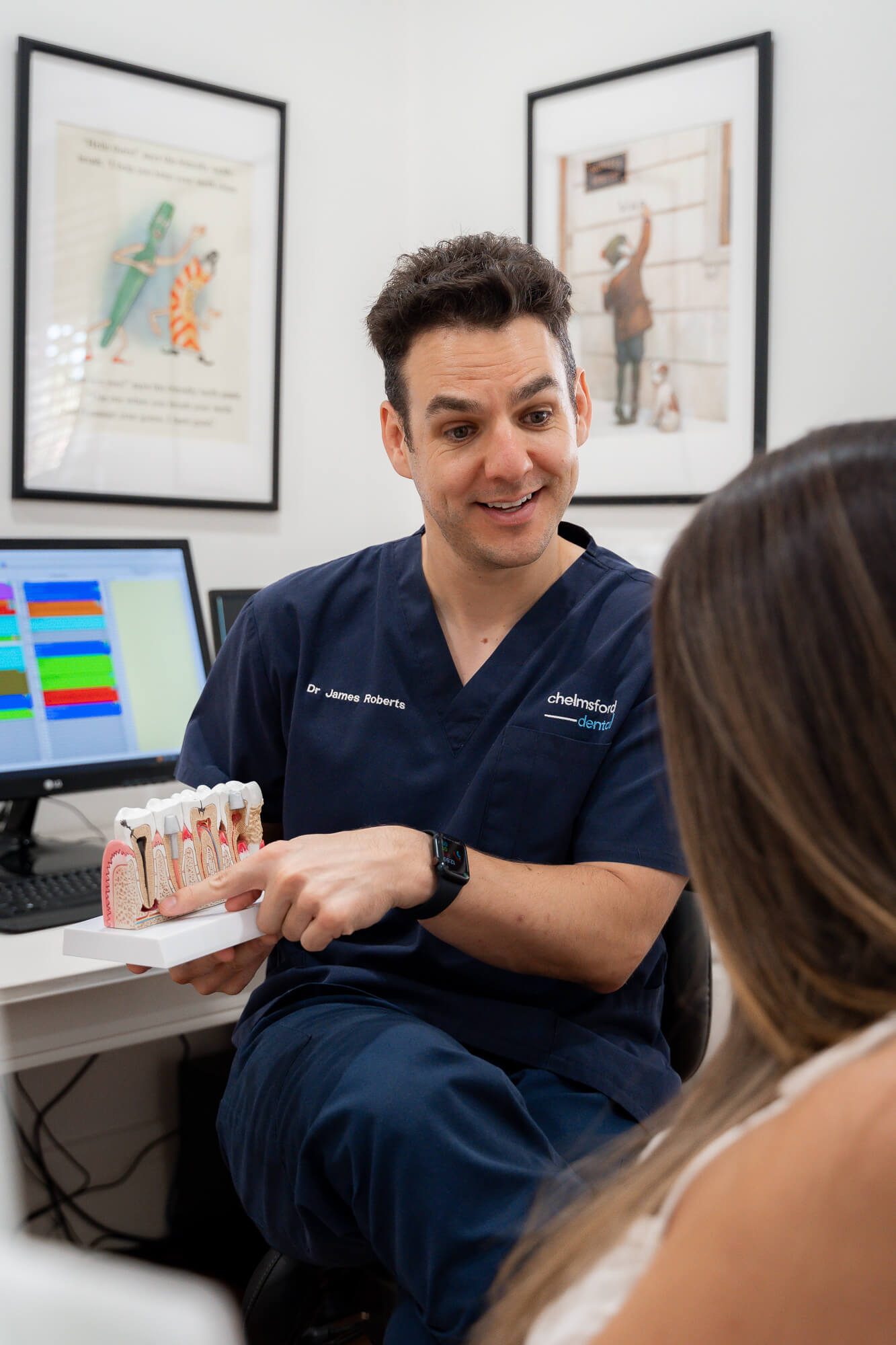 Chelmsford Dental Mount Lawley dentist showing tooth model to patient