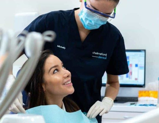 Dental patient smiling after teeth whitening kit