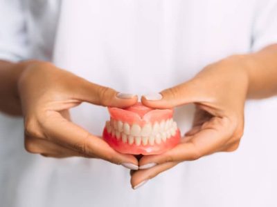 Dentist holding dentures.