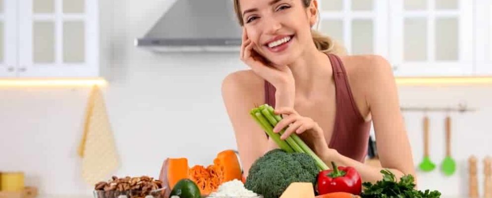 lady with a group of healthy foods that are good for oral hygiene